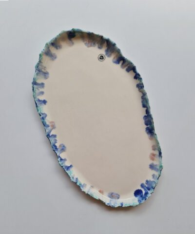a unique plate with blue running glazes
